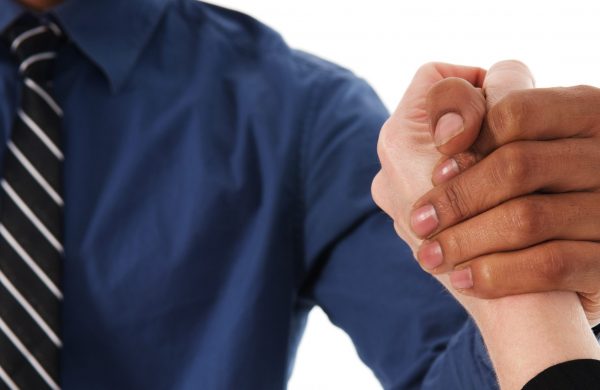 businessman shaking hands with colleague on white